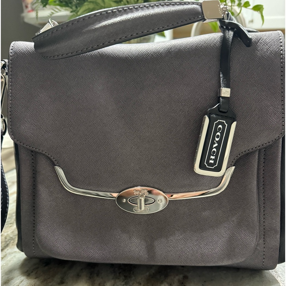 Coach handbag with turn lock closure